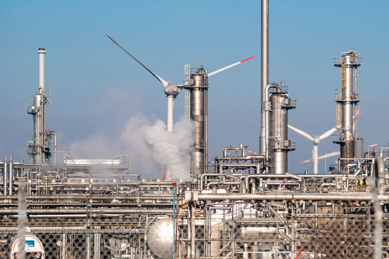 Chemieindustrie mit Windenergieanlage - Symbolbild für den Förderwettbewerb BIK zur Dekarbonisierung der Industrie.