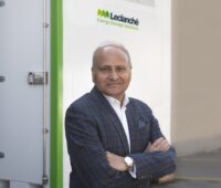 Zu sehen ist Anil Srivastava, CEO von Leclanché vor dem Container mit dem LeBlock-Batteriespeicherkonzept.