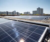 Eine PV-Anlage auf einem Flachdach, in der die Sonne reflektiert.