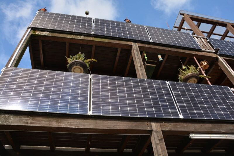Photovoltaik an der Außenfassade von bayrischen Holzbalkonen.