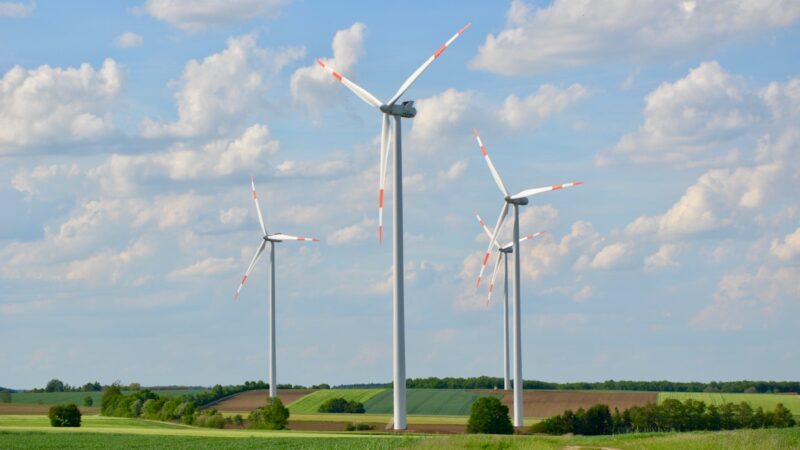 Ü20-Windenergie-Anlagen vor blauem Himmel mit Schäfchenwolken