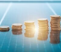 Geldmünzen auf Photovoltaik-Modulen, Berenberg finanziert das Aufdach-Portfolio von Enviria.