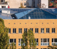 Auf dem verglasten Dach einer Fachhochschule sind Solarmodule installiert