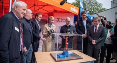 Im Bild sind Bundeskanzler Olaf Scholz und weitere prominente Politiker:innen, die die Inbetriebnahme vom Geothermie-Heizwerk in Schwerin besuchten.