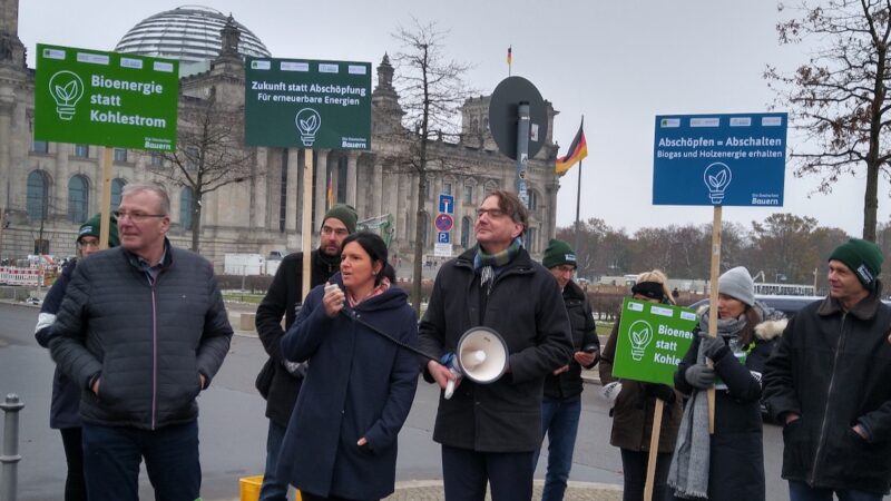 Menschen mit Schildern und Megafon - Demonstration gegen Erlösabschöpfung in der Bioenergie-Branche