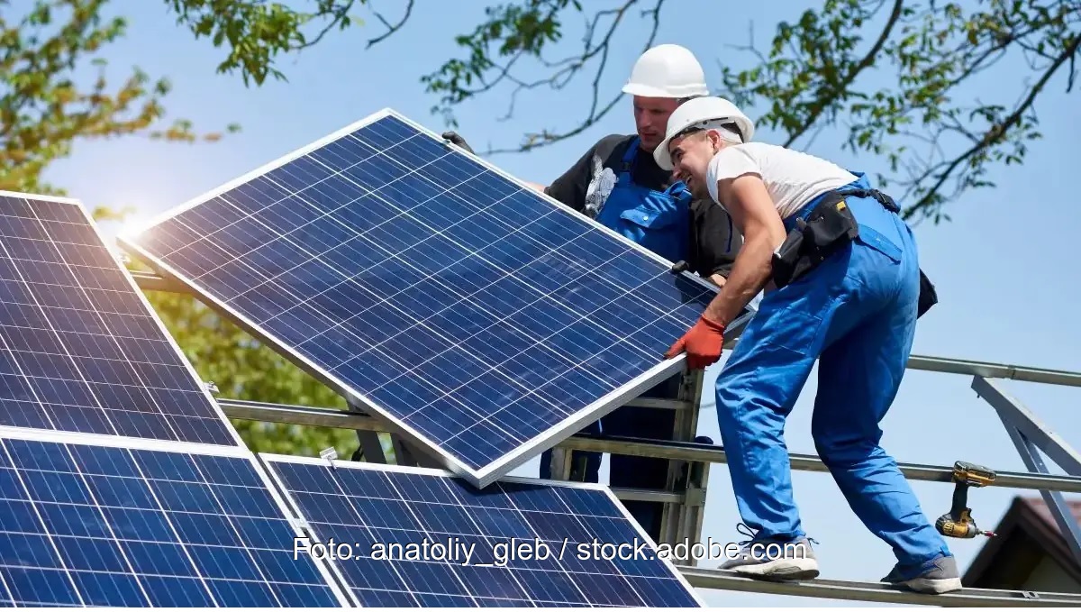 Zwei Monteure installieren eine Solaranlage, Photovoltaik erfordert keinen zusätzlichen Netzausbau.