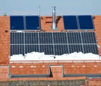 Zu sehen ist ein winterliches Dach mit Photovoltaik und Solarthermie. Mit dem Solarkataster in Baden-Württemberg können Bürger:innen die Wirtschaftlichkeit berechnen.