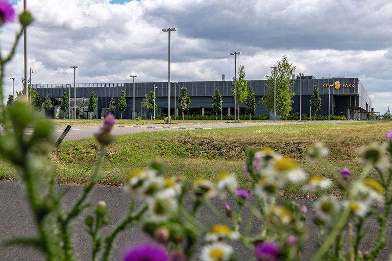 Eine moderne Fabrik - ein Flachbau auf der grünen Wiese.