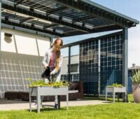 Ein Mädchen unter einer Solarüberdachung, der Photovoltaik-Zubau in Österreich ist gesunken.