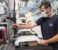 Zu sehen ist ein Arbeiter in der Fertigung von SMA, das Unternehmen hat ein erfolgreiches Geschäftsjahr 2022 verkündet.