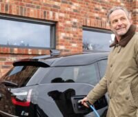 Zu sehen ist ein E-Autohalter, der von dem Service von Solarwatt betreffend der THG-Zertifikate profitiert.