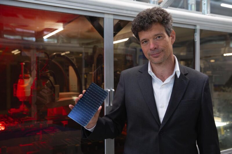 Mann mit Mini-Solarmodul in der Hand - Solarwatt-CTO Froitzhem mit TopCon-Modell.