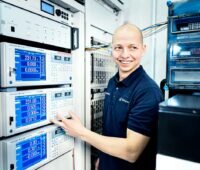 Ein TÜV-Prüfer an einem Prüfstand für PV-Anlagen.