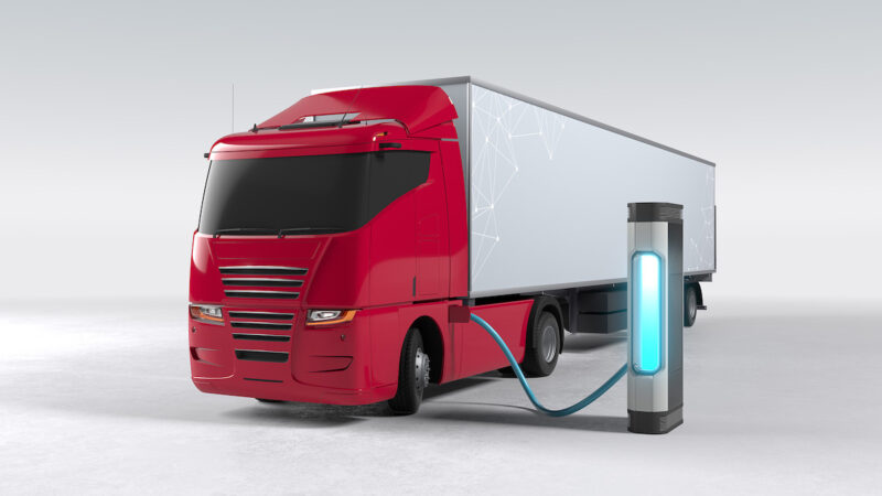 Grafische Darstellung eines E-LKW an einer Ladesäule