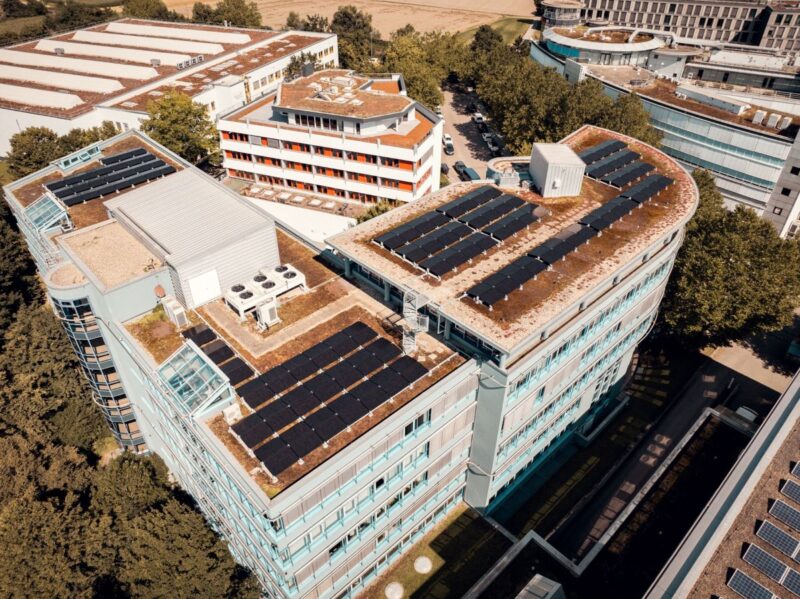 Luftbild einer PV-Anlage auf dem Dach eines Gewerbe-Hochhauses.