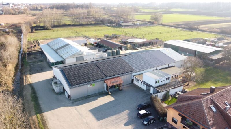 Luftaufnahme eines landwirtschaftlichen Betriebs mit Photovoltaik auf einem der Dächer.