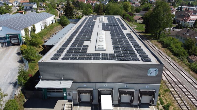 Das Dach eines Industriegebäudes ist komplett mit Solarstrommodulen bestückt.